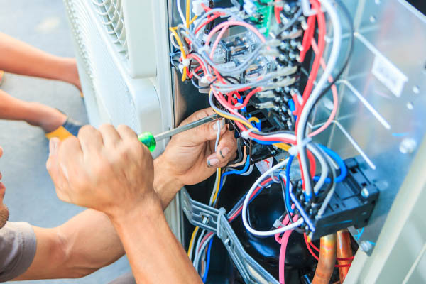 image of an hvac contractor performing air conditioner tune-up service