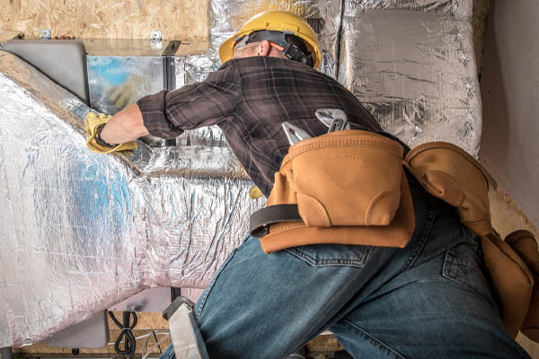 image of an hvac contractor repairing hvac ductwork