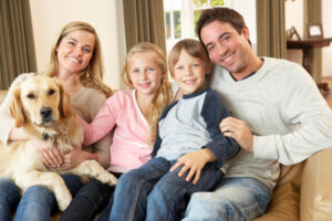 family at home with dog depicting indoor air quality with pets