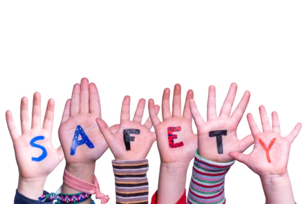 Safety spelled using painted letters on hands depicting air conditioner safety switch activation