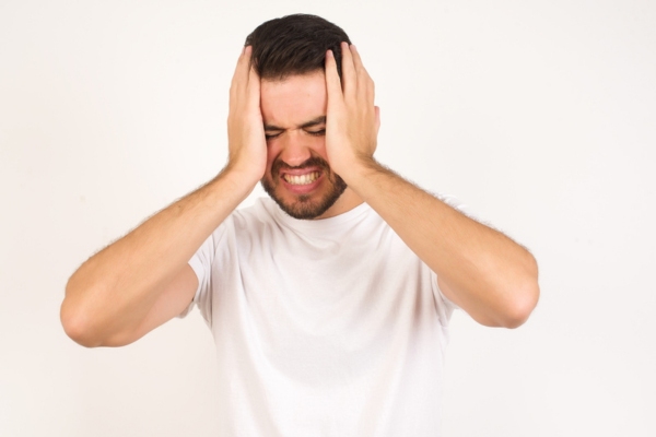 man with palms on face depicting frustration due to issues with the contactor